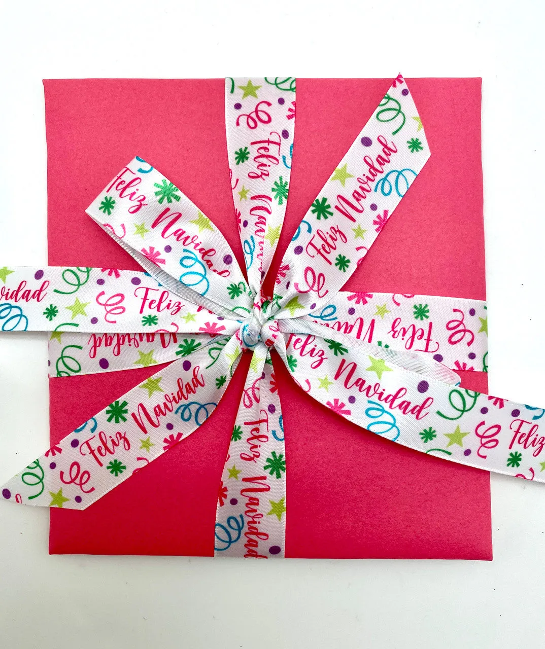Feliz Navidad Ribbon with confetti and streamers in pink, green, blue and purple printed on 7/8" white single face satin 10 yrds